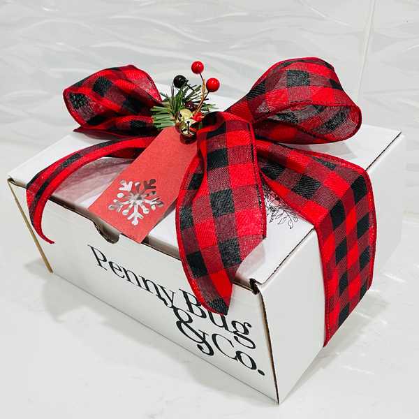 The box's packaging. White box with red and black bow.